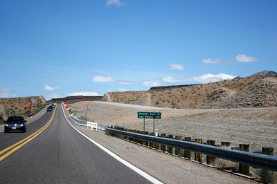 Road by mountain against sky