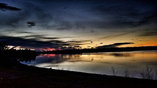 Scenic view of lake against sky at sunset