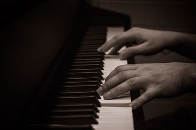 Close-up of man playing piano