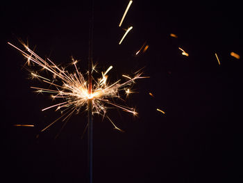 Low angle view of firework display at night