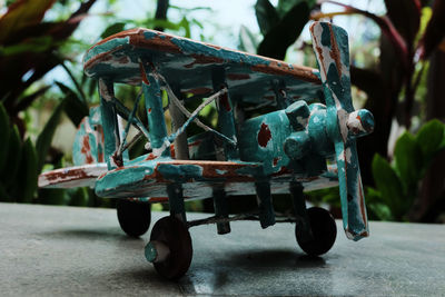 Close-up of rusty wheel wooden airplane