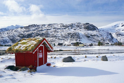 Snow covered land and mountains against sky