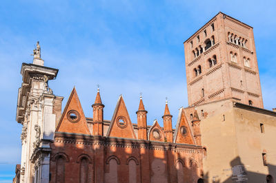 Low angle view of clock tower against blue sky