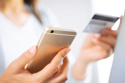 Midsection of woman using mobile phone