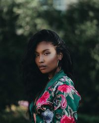 Portrait of young woman standing outdoors