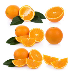 Close-up of orange fruits against white background