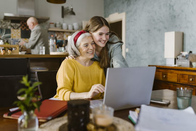 Young woman using laptop at home