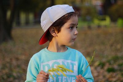 Cute boy standing on field