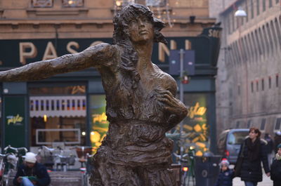 Statue in city at night