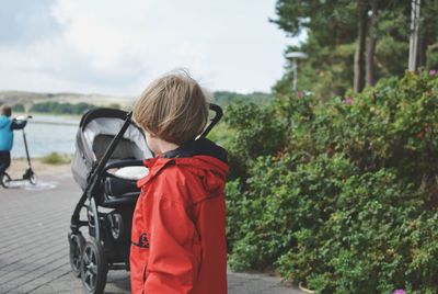 Rear view of woman standing by plants
