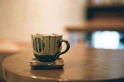 Close-up of coffee cup on table