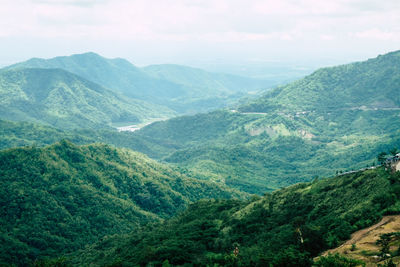 High angle view of valley and mountains against sky