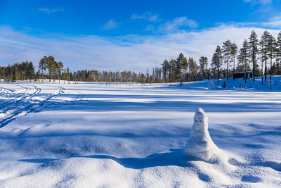 Snow covered field against sky