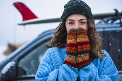 Woman surfer portrait with frozen surfboard