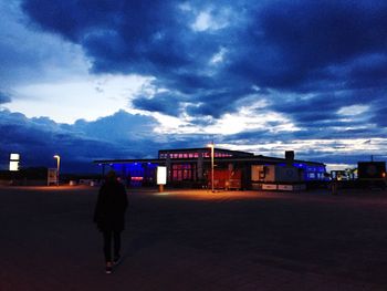 Silhouette of woman against cloudy sky