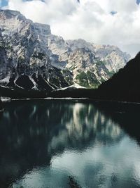 Scenic view of lake by mountains against sky