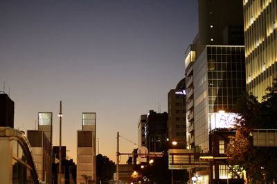 Low angle view of illuminated buildings against sky at dusk