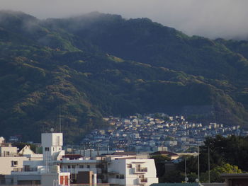 High angle view of townscape and mountains against sky