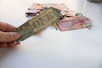Cropped hand holding paper currency