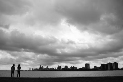 Cityscape against cloudy sky