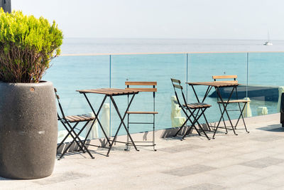 Wooden chairs and table overlooking spectacular seaside view