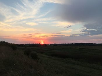 Scenic view of field against sky during sunset