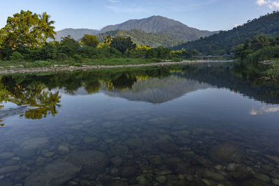 Scenic view of lake and mountains against sky