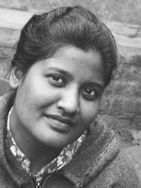 Close-up portrait of smiling young woman