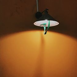 Low angle view of electric lamp hanging on ceiling