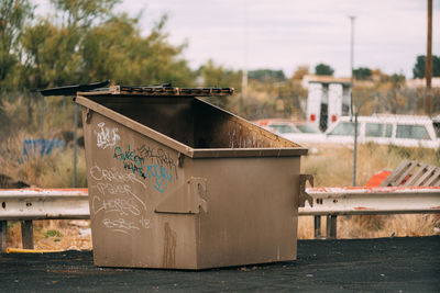Close-up of garbage bin against built structure