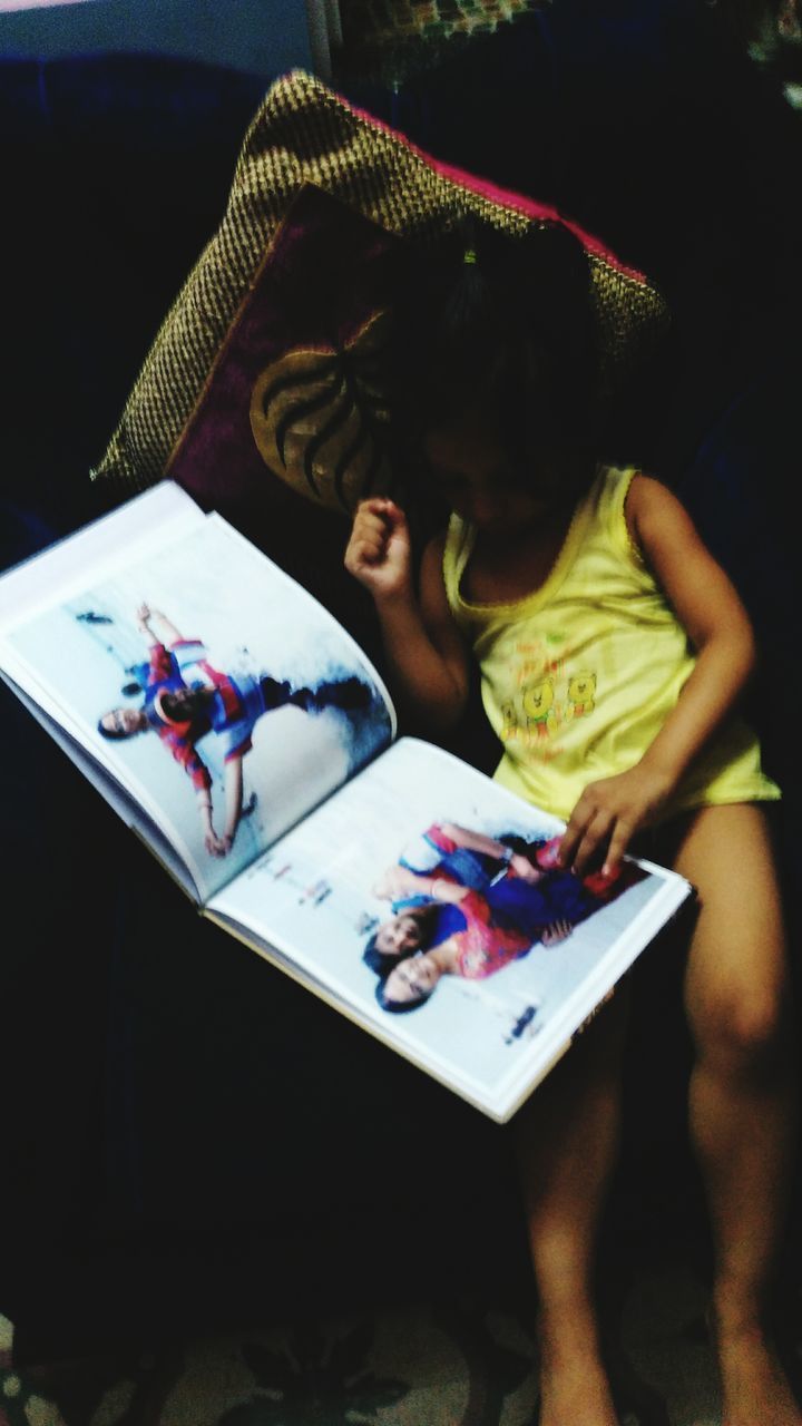 HIGH ANGLE VIEW OF YOUNG WOMAN USING LAPTOP AT HOME