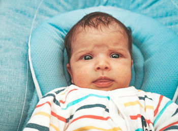 Portrait of cute baby lying on bed