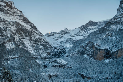 Scenic view of snowcapped mountains against clear sky