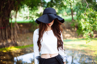 Woman wearing hat standing on land