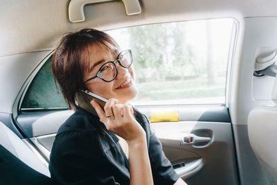 Portrait of woman sitting in car