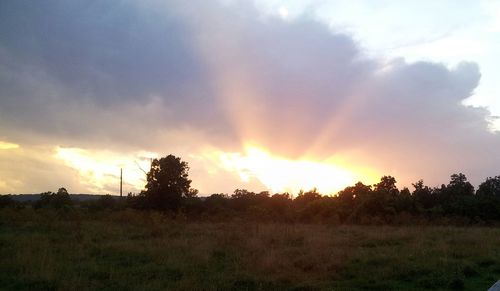 Scenic view of landscape against sky at sunset