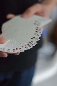 Close-up of man holding cards