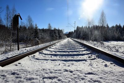 View of railway tracks against snow covered landscape