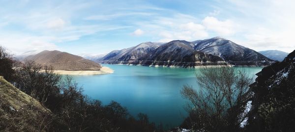 Scenic view of lake and mountains against sky