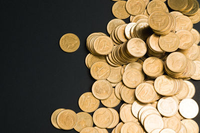 High angle view of coins on black background