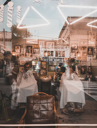 Rear view of people standing at store