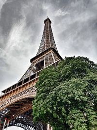 Low angle view of bridge tower against cloudy sky