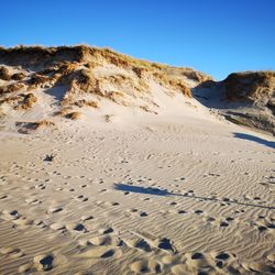 Scenic view of desert against clear sky