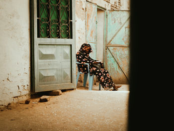 Low section of woman standing by window