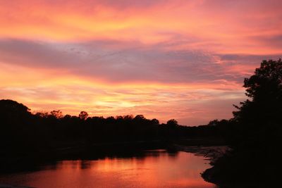 Scenic view of lake against orange sky