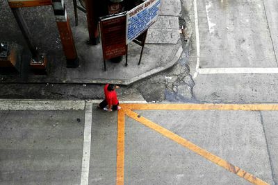 Directly above shot of man walking on road