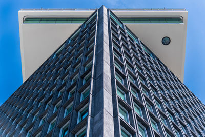 Low angle view of modern building against clear blue sky