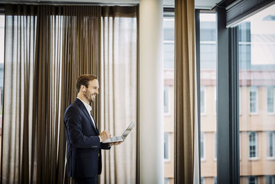 Side view of a man using mobile phone