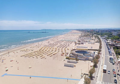 High angle view of city by sea against sky