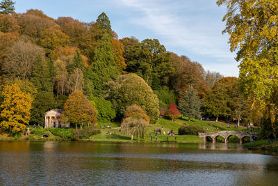 View of the autumn colours around the lake at stourhead gardens in wiltshire.